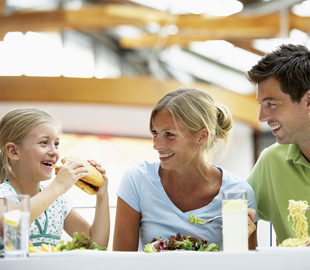 Parents eating with daughter