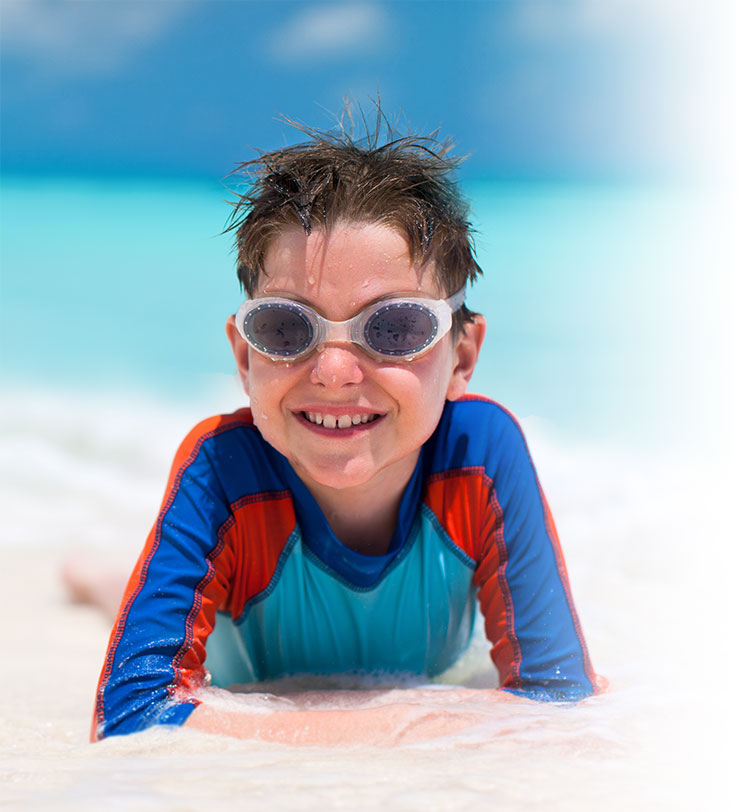 Boy laying on beach