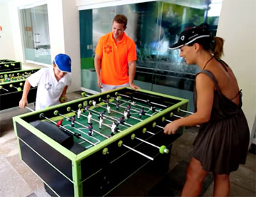 Family playing foosball