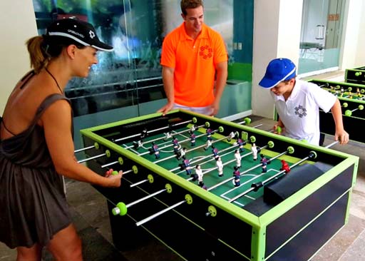 Family playing foosball